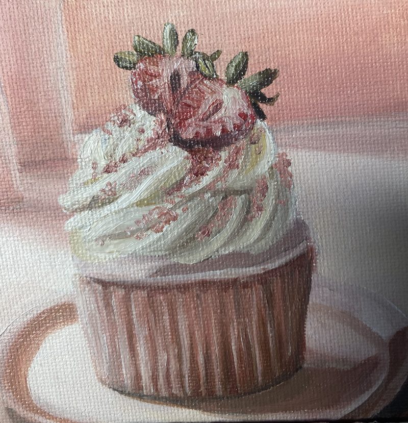 Still life painting of a cupcake with thick swirled white frosting, strawberry slices on top, in a fluted paper case on a pale plate against a pink background.