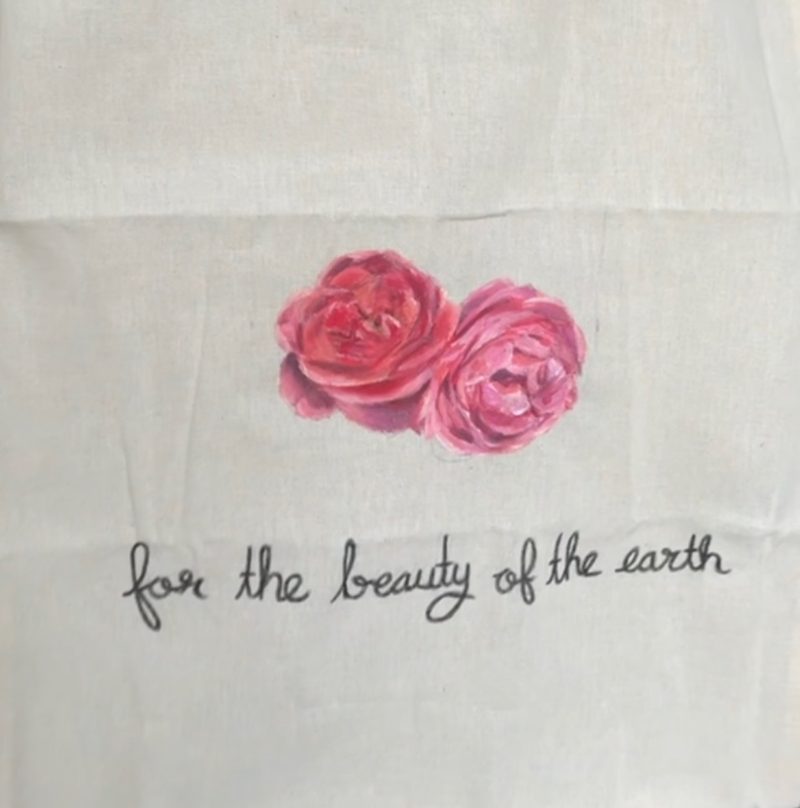 Close-up of the two painted roses and the script lettering.