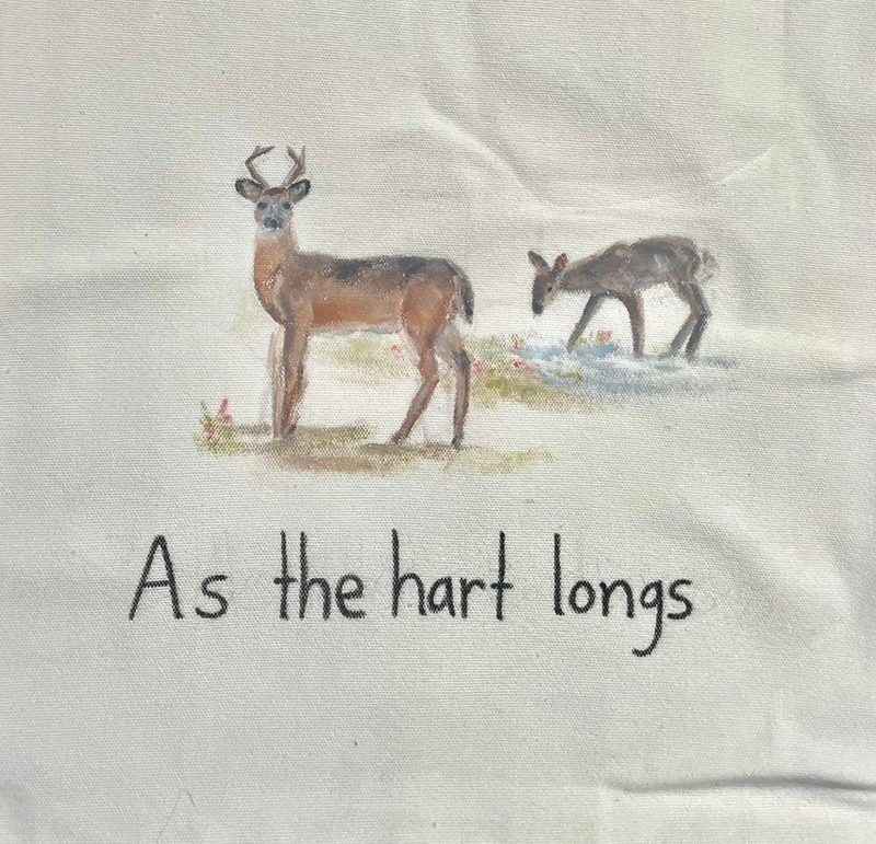 Close-up of the painted buck and fawn at the water.