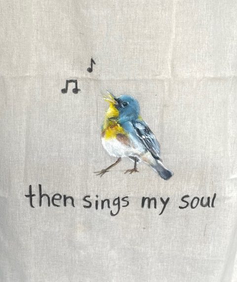 Close-up of the painted warbler and the two music notes.